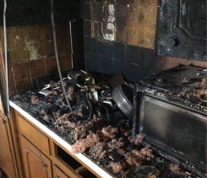 fire damaged kitchen cabinets and fire debris