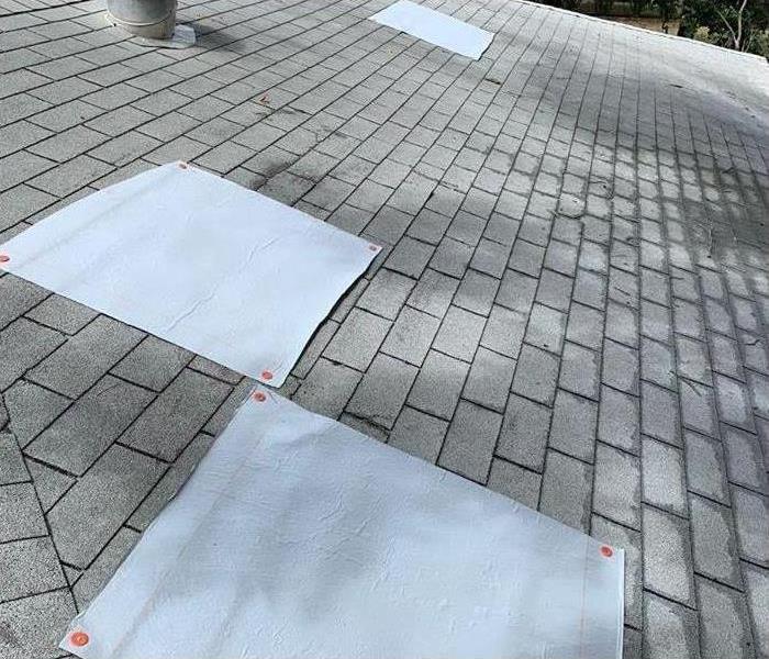 roof with gray tarps