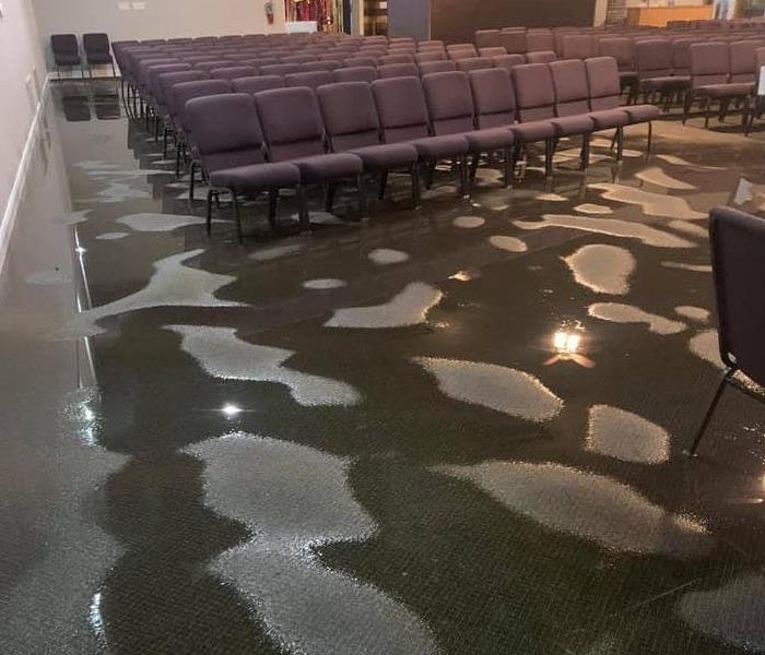 water pooled on carpet, church pews