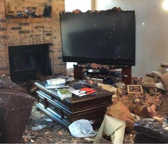 living room, big tv, fireplace, fire damage debris