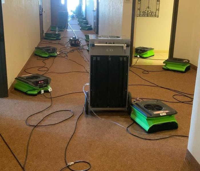 carpeted hallway with green equipment