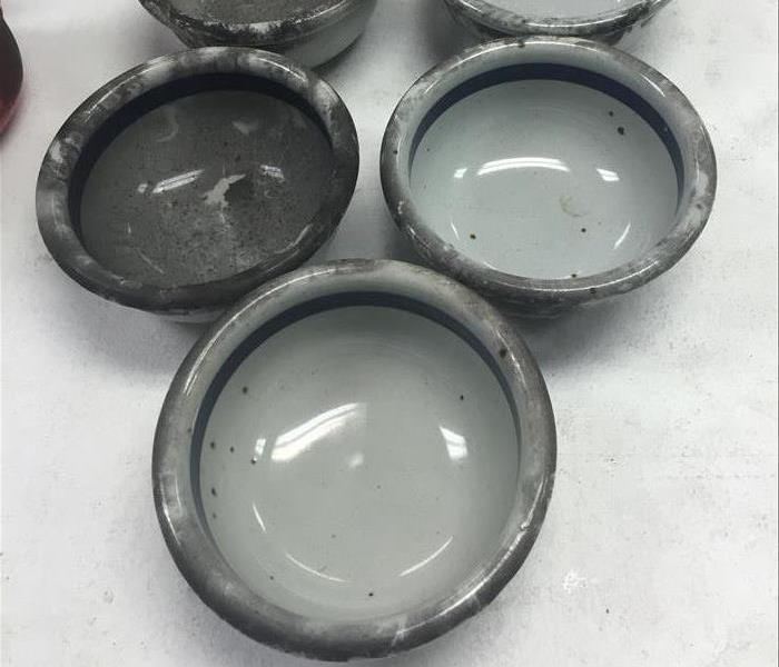 gray dishes covered in soot