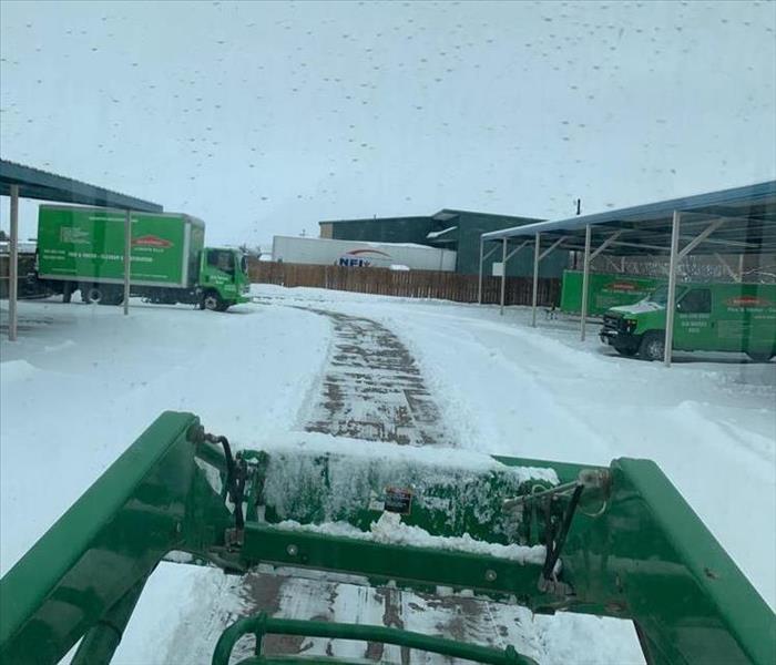 green trucks in snow