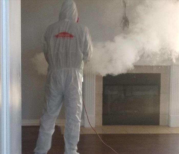 living room, man in white PPE