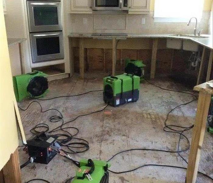 kitchen, bare floors, no cabinets, green equipment