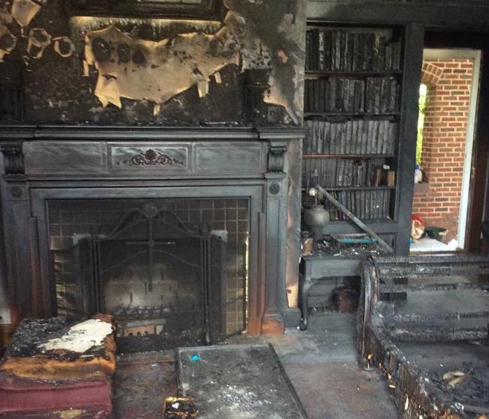 burned fireplace and bookcase
